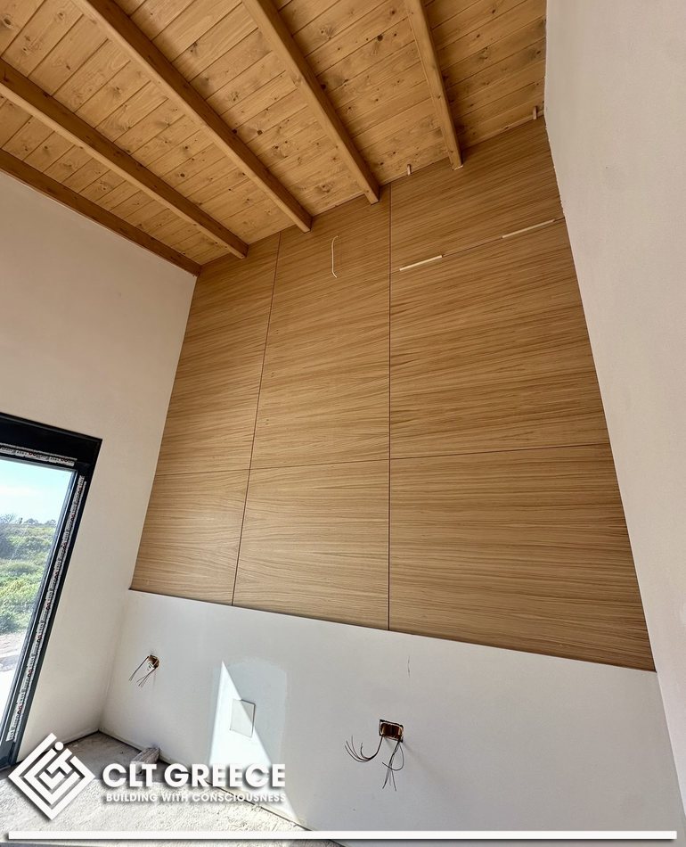 Inside the CLT house in Preveza: timber ceiling, beams and wall lining