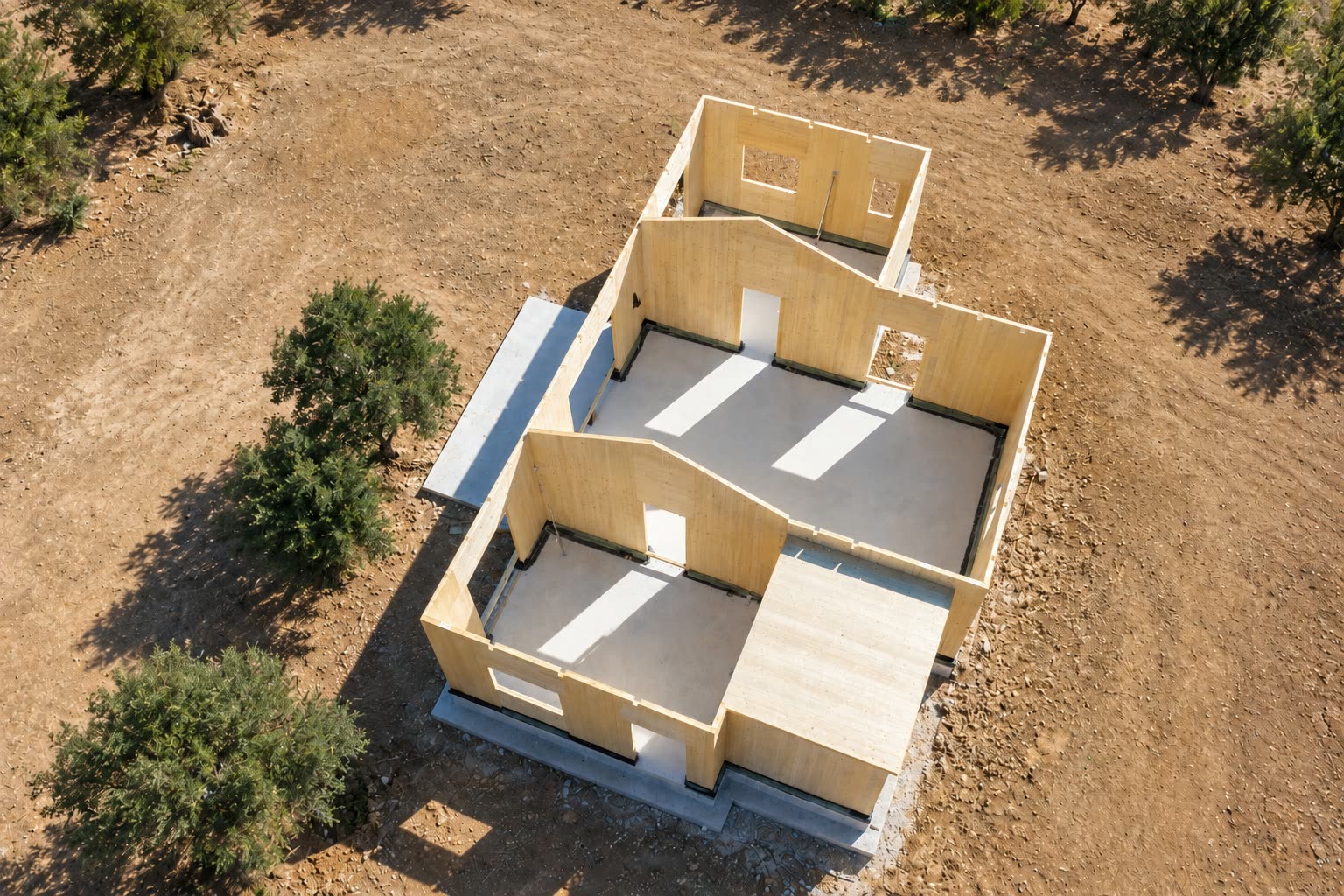 Aerial view of the completed CLT shell of the residence in Vasiliki, Lefkada, among olive trees