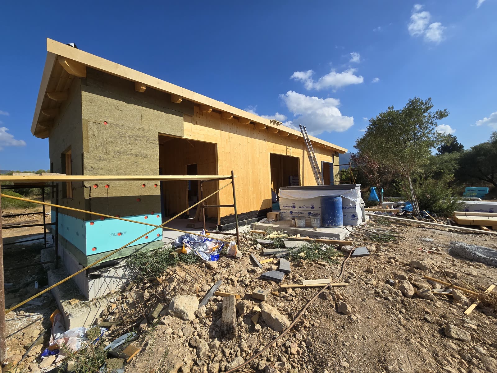 Side view of the CLT house in Vasiliki with its Glulam timber roof and envelope insulation